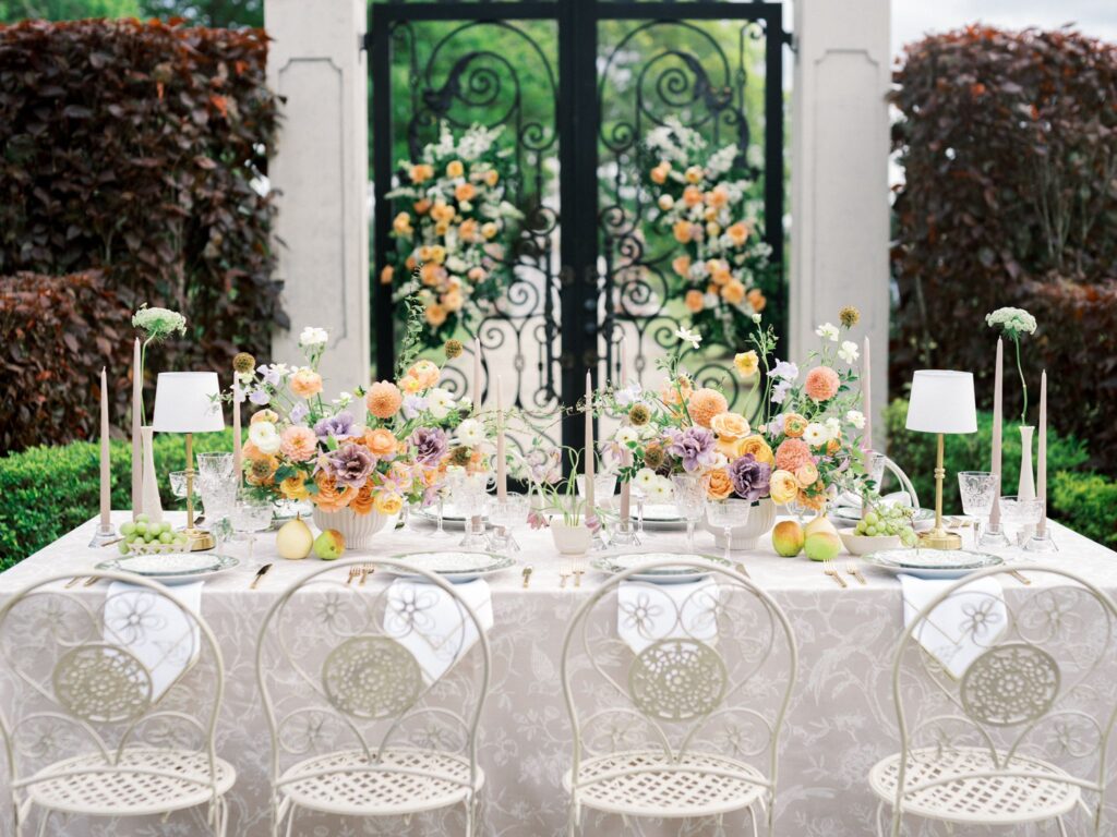 Colorful event table setup beside the garden gates at Cinco Farm in Miami
