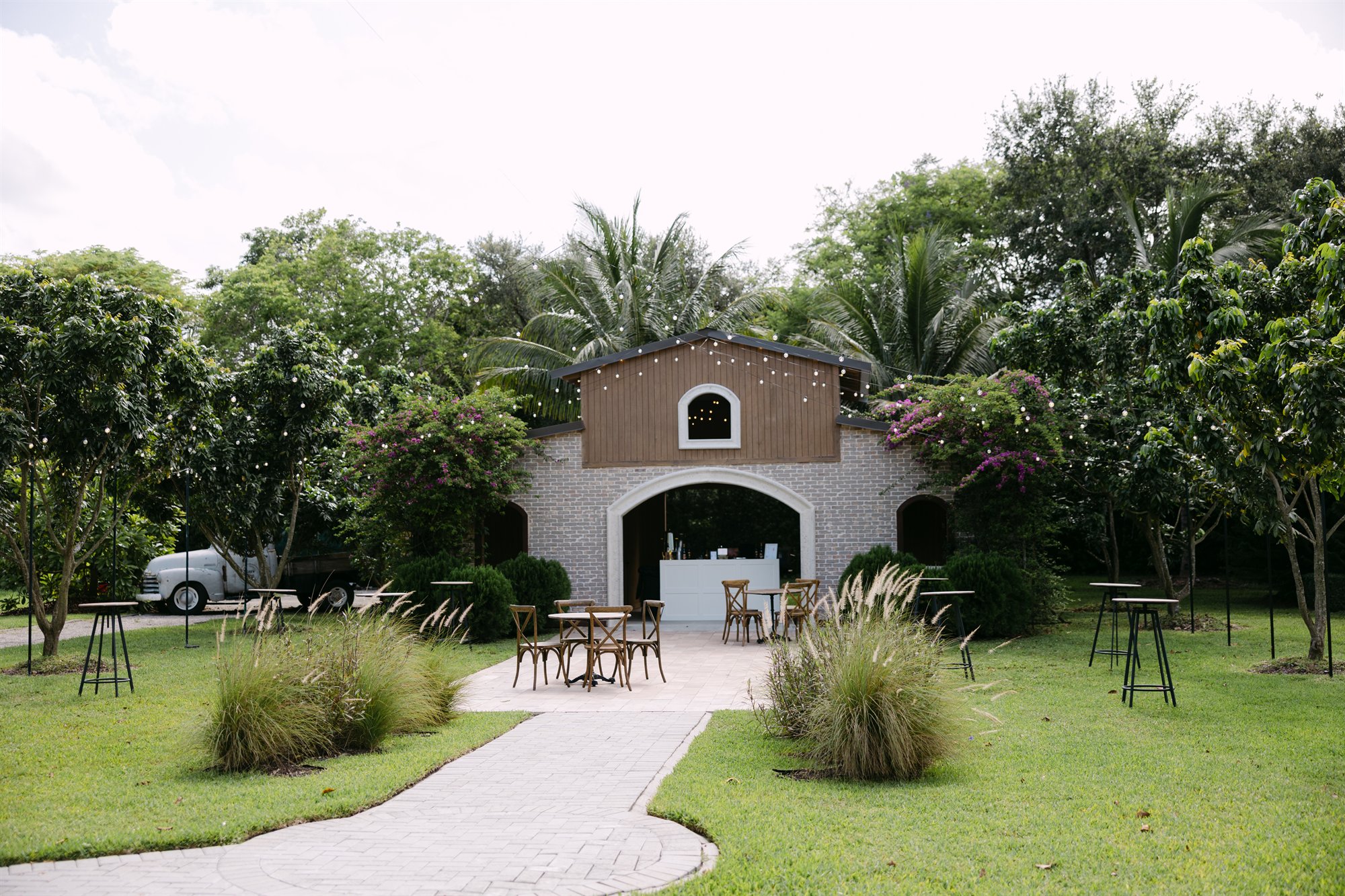 Rustic open-air cocktail and gathering space surrounded by greenery at Cinco Farm