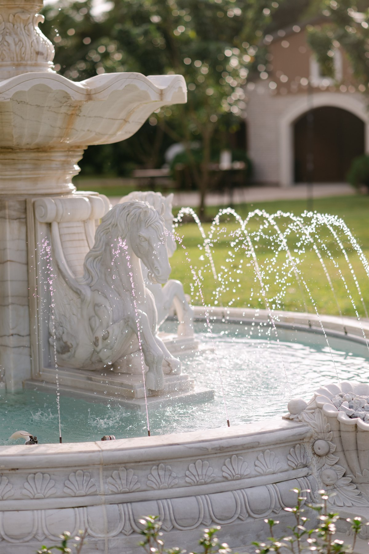 Ornate estate fountain and tropical garden at Cinco Farm wedding venue in Miami