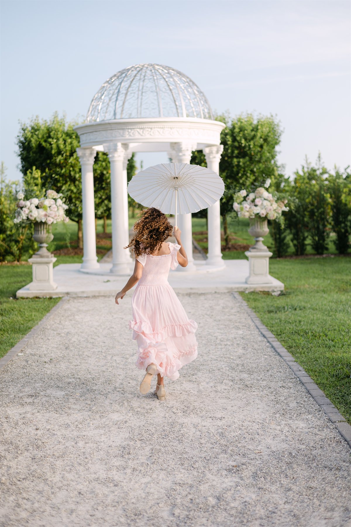 Child walking toward the floral gazebo at Cinco Farm