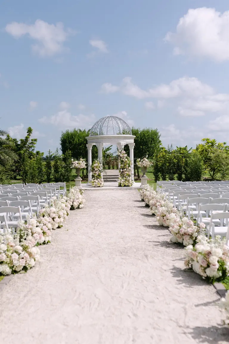 Outdoor wedding ceremony gazebo and floral aisle at Cinco Farm in Miami