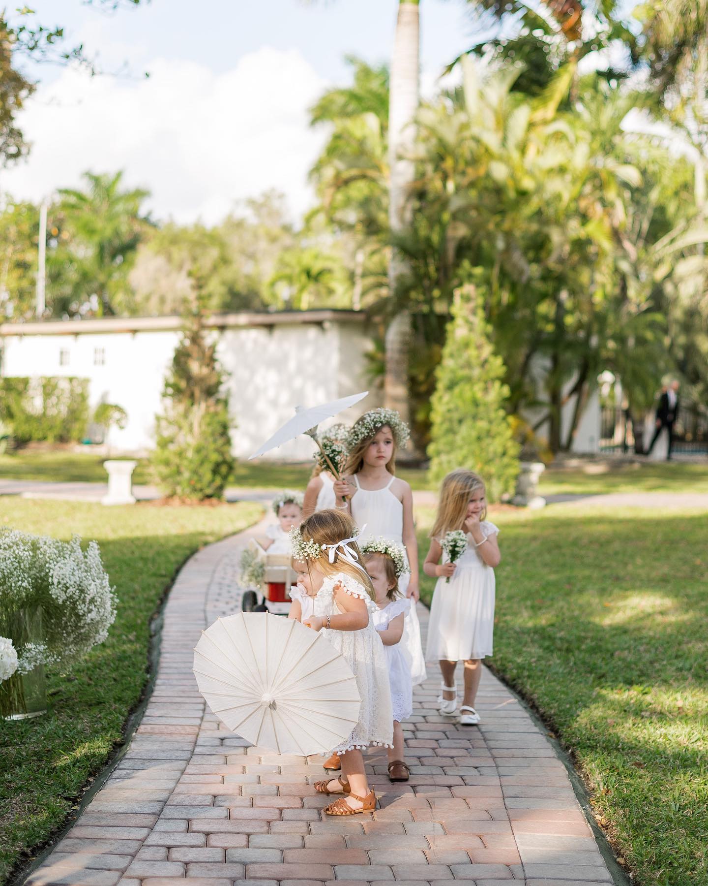 Flower girls walking through the gardens at an intimate Miami wedding
