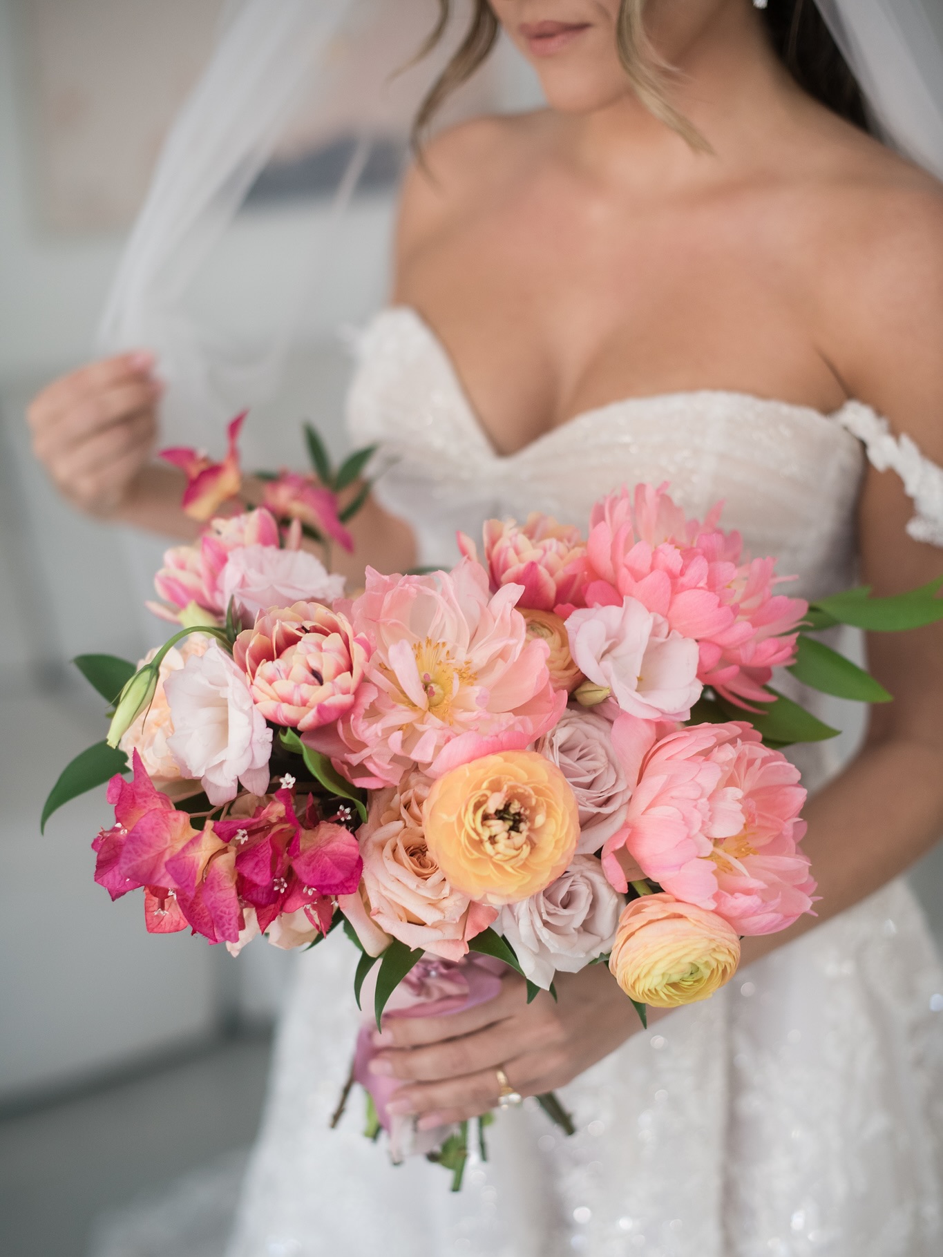 Bride with a colorful bouquet at Cinco Farm garden wedding venue