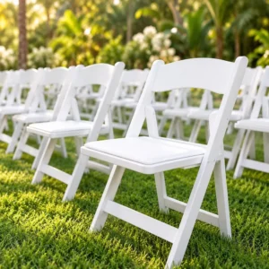 Rows of white folding chairs arranged on the lawn for a garden ceremony